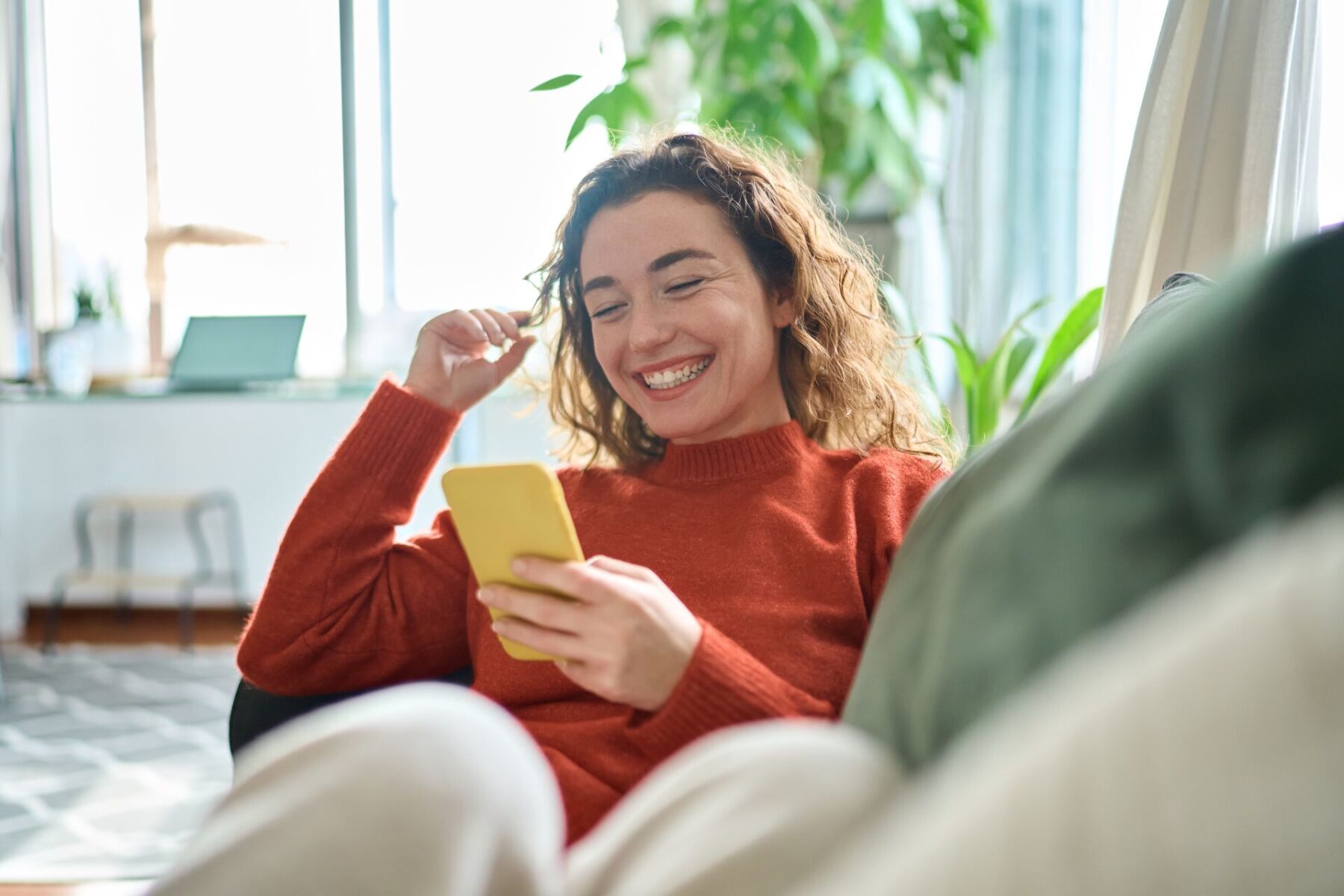 young woman on the phone happy about having clear vision